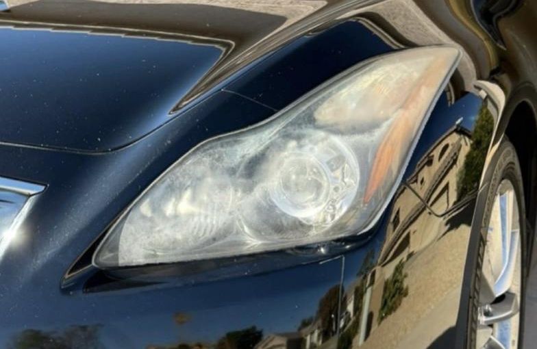 Infiniti headlight before restoration — hazy and oxidized